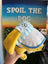 Yellow plush dog toy with a striped shirt held in front of a sign that says 'Spoil the Dog'.