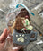 Hot Chocolate cookie with a paw print design, and dog safe hot chocolate pack held in a clear plastic bag.