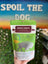 Hand holding a package of Bison Crisps with a blurred background featuring 'Spoil the Dog' text.