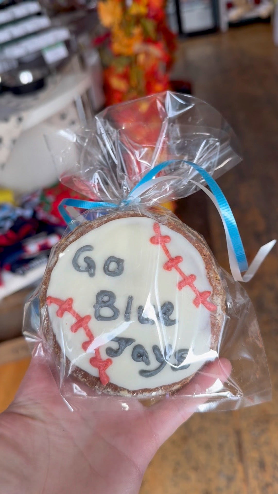 Cookie with 'Go Blue Jays' text and baseball design, wrapped in clear plastic.