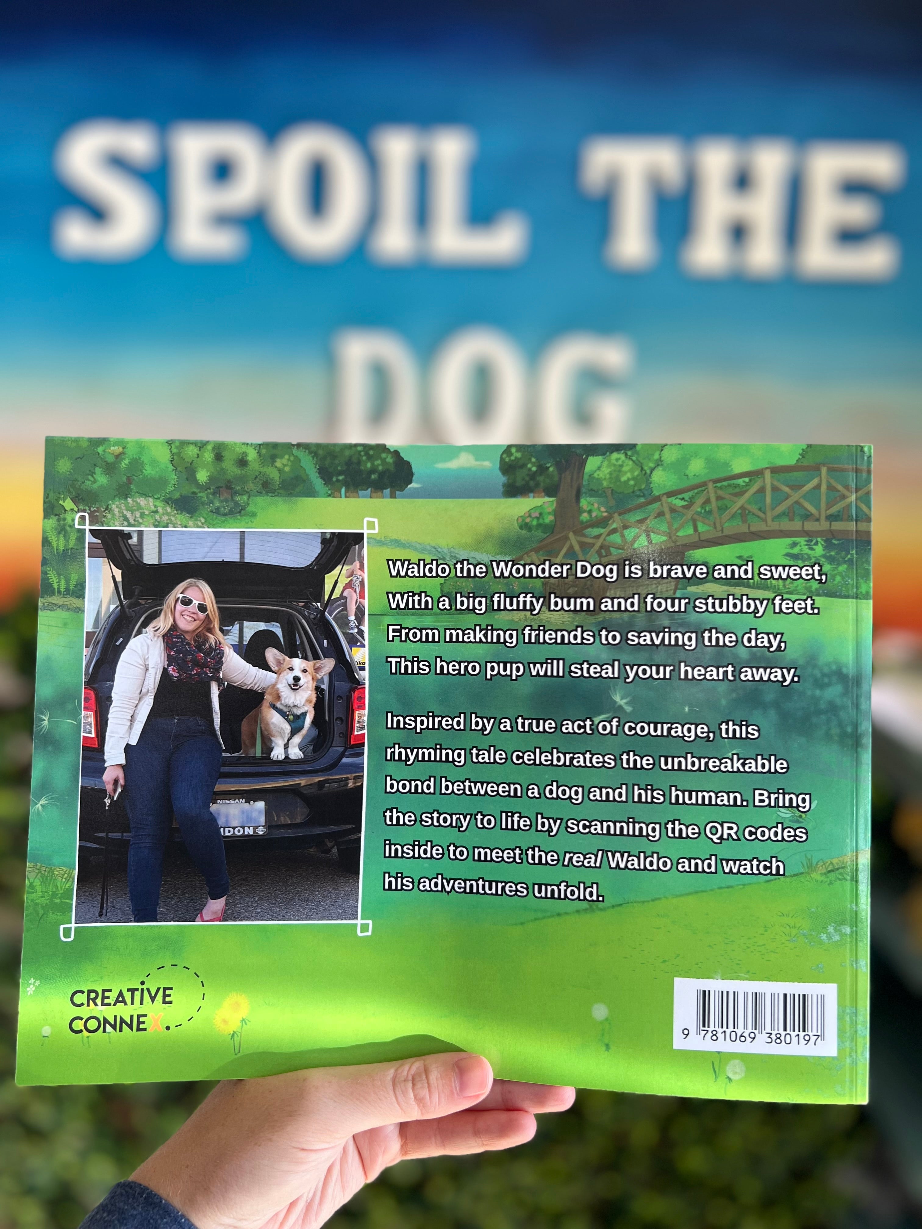 Book titled 'Waldo the Wonderdog' held by a hand with a blurred background