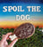 Hand holding a dog treat shaped like a drumstick, with 'Spoil the Dog' text and a scenic background