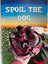 Snuffle ball held by a hand with 'Spoil the Dog' sign in the background