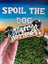 Dog bone-shaped treat with chocolate and white icing held by a hand, with 'Spoil the Dog' sign in the background.