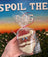 Hand holding a gingerbread cookie shaped like Santa Claus in front of a scenic background with text.