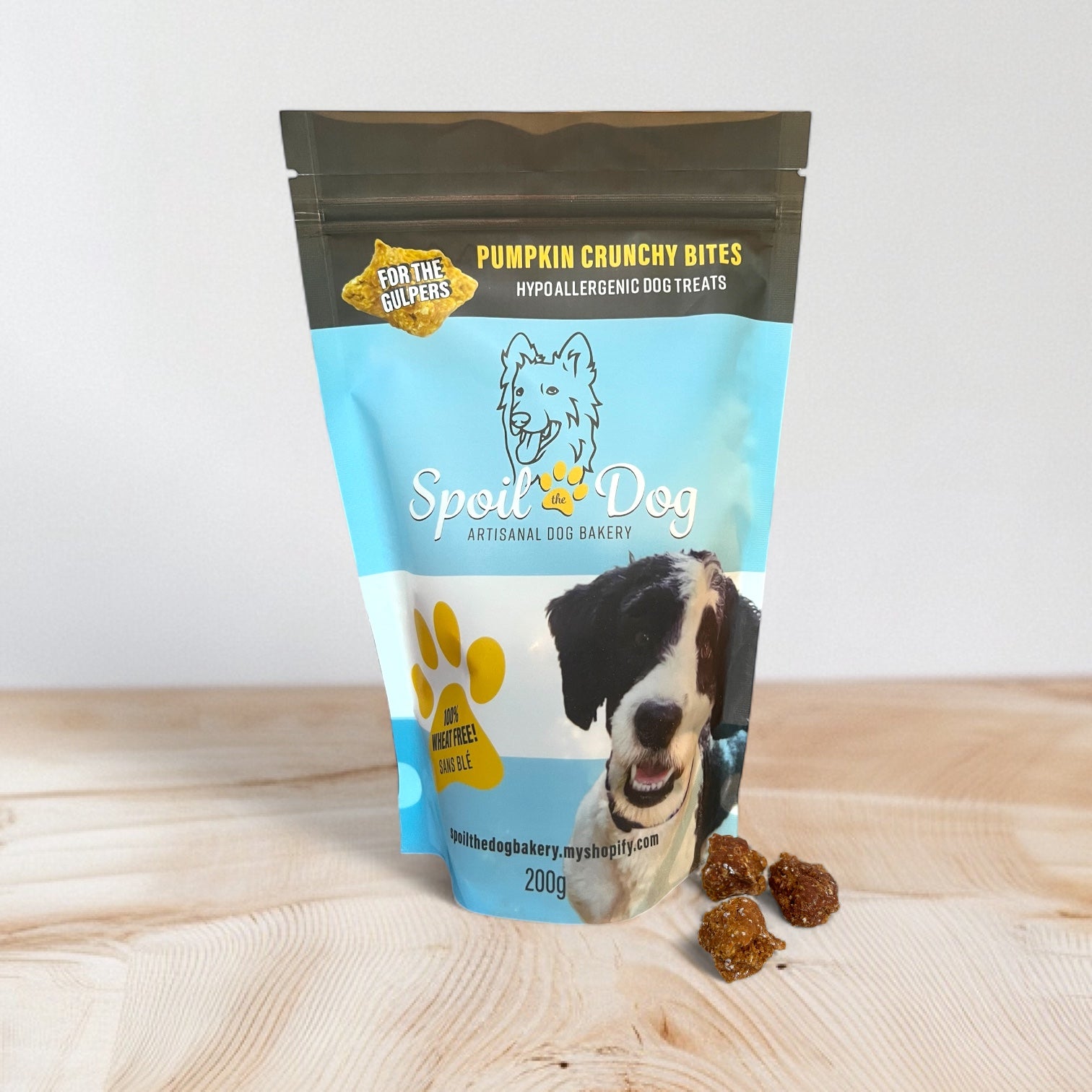 Spoil Dog pumpkin crunchy bites packaging on a wooden surface with a white background