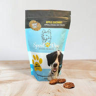 A package of Spoil the Dog bakery dog treats in Apple Coconut flavor, with a visual of a dog and the treats displayed in front.