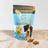 A package of Spoil the Dog brand wheat-free dog treats in Cheesy Cheddar & Parsley flavor, with a bag showing a white and black dog and the product name.