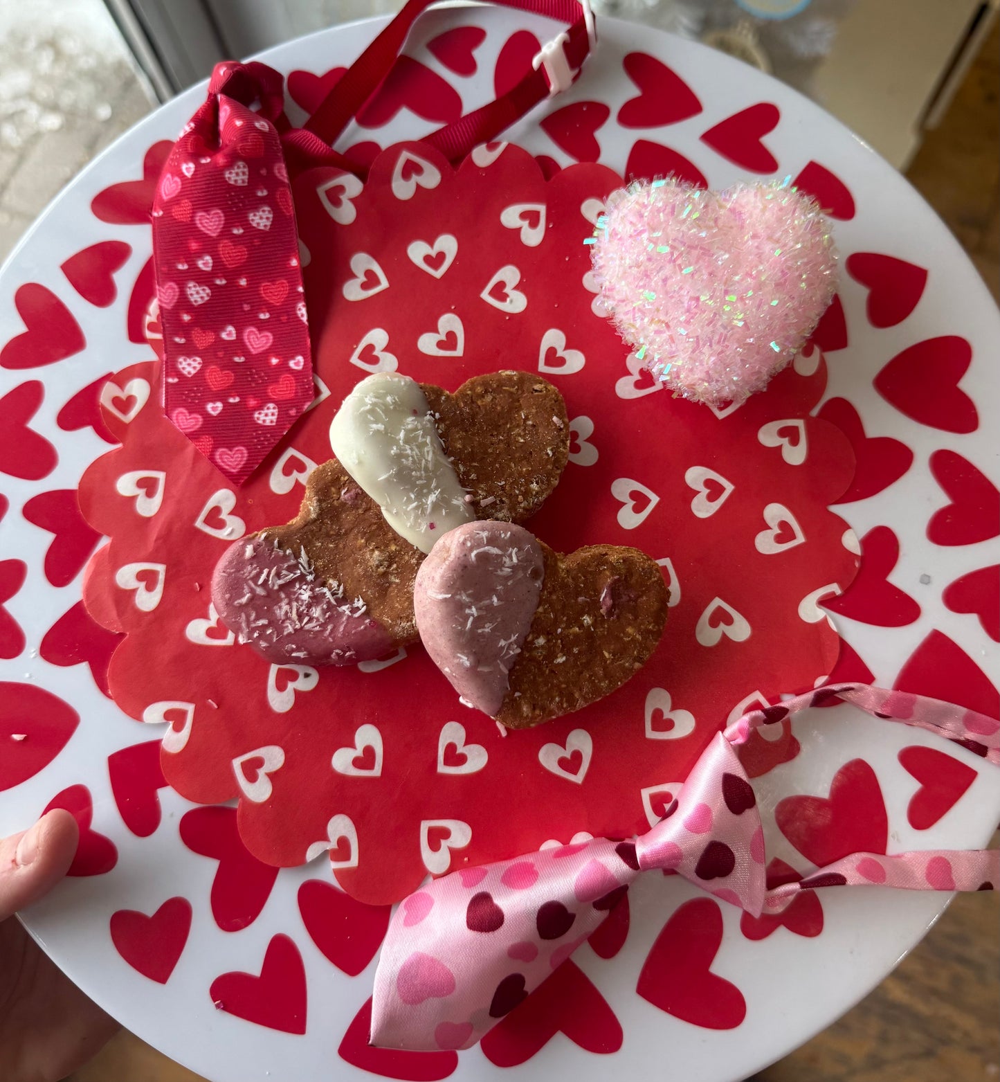 Heart-shaped cookies on a plate with red and white heart pattern