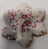 Snowflake dog cookie with purple sprinkles on a white background